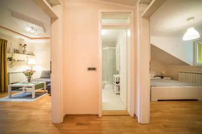 a hallway leading to a bedroom with a bed at Skadarlija City Break in Belgrade