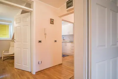 a hallway with a door leading to a kitchen at Skadarlija City Break in Belgrade