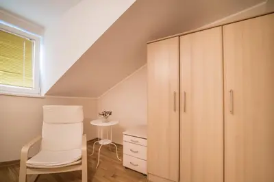 a room with a white chair and a cabinet at Skadarlija City Break in Belgrade