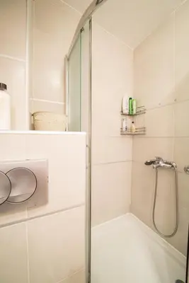 a bathroom with a shower and a bath tub at Skadarlija City Break in Belgrade