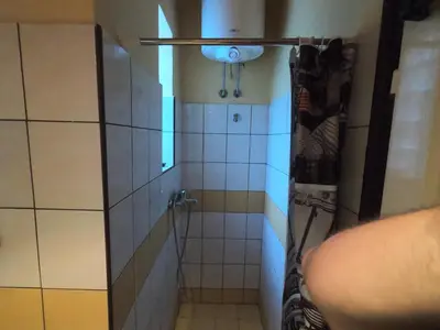 a small bathroom with a shower with a sink at Aprtman Sonja 2 in Belgrade