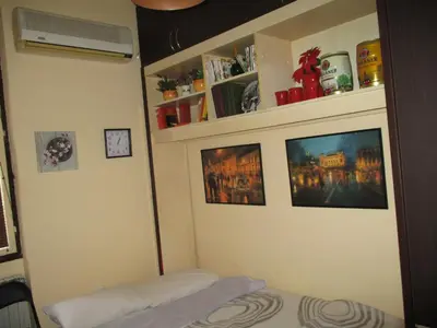 a room with a bed and some pictures on the wall at Aprtman Sonja 2 in Belgrade