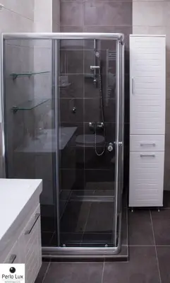 a shower with a glass door in a bathroom at Perla Lux Apartments in Arandjelovac