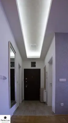 a hallway with a white ceiling and a black door at Perla Lux Apartments in Arandjelovac