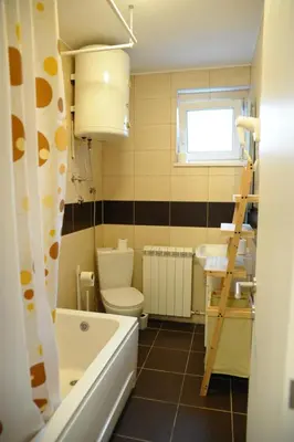 a bathroom with a tub and a toilet and a sink at Apartment A in Belgrade