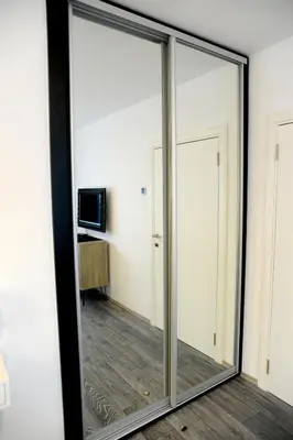 a large glass mirror in a room at Apartment A in Belgrade