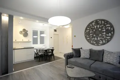 a living room and kitchen with a couch and a table at Apartment A in Belgrade