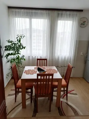 a dining room table and chairs in a room at Apartman LENA in Arandjelovac