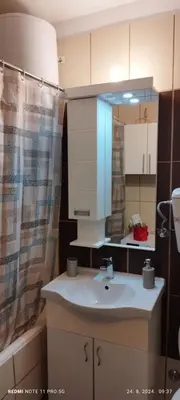 a bathroom with a sink and a mirror at Apartman LENA in Arandjelovac