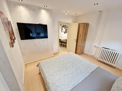 a living room with a flat screen tv on a wall at Apartmani Paku in Belgrade
