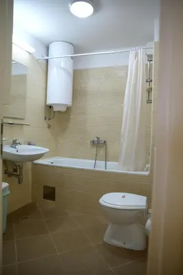 a bathroom with a toilet and a tub and a sink at Zap apartman in Belgrade