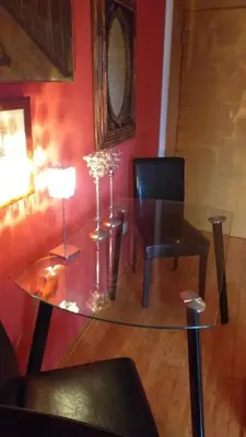 a dining room with a glass table and a chair at LOVE in Belgrade