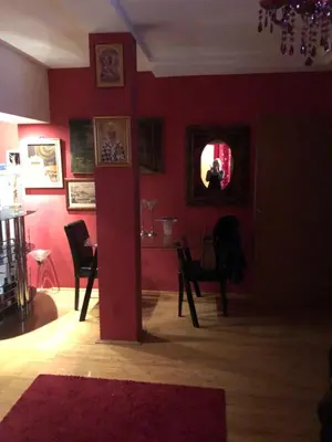 a living room with red walls and a table and chairs at LOVE in Belgrade
