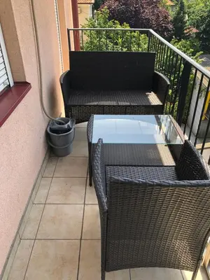a balcony with a table and chairs on a balcony at LOVE in Belgrade