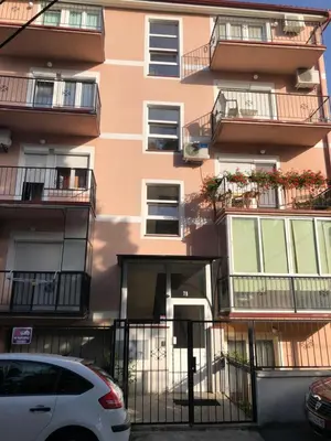 a building with balconies and a car parked in front at LOVE in Belgrade