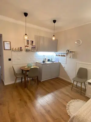 a kitchen with a table and chairs in a room at Apartment 42 - City Center in Belgrade