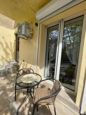a patio with a table and chairs on a porch at Apartment 42 - City Center in Belgrade