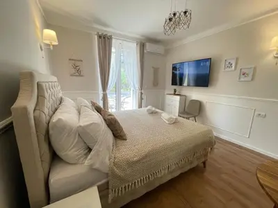 a bedroom with a bed and a tv on the wall at Apartment 42 - City Center in Belgrade