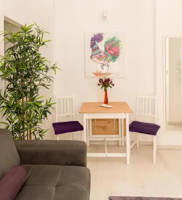 a living room with a couch and a table at Rooster apartments in Belgrade