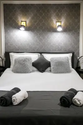 a bedroom with a large bed with towels on it at Natalie's Place in Belgrade