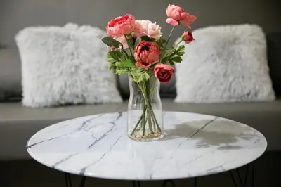 a vase filled with pink flowers on a table at Natalie's Place in Belgrade