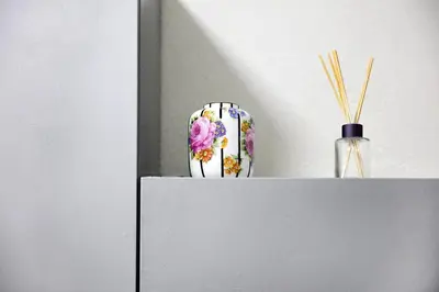 a vase sitting on top of a white shelf at Natalie's Home in Belgrade