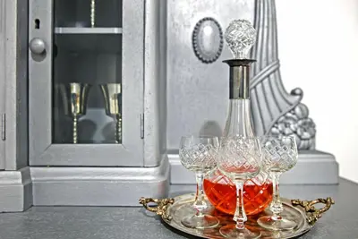 a bottle of wine on a tray with three wine glasses at Natalie's Home in Belgrade