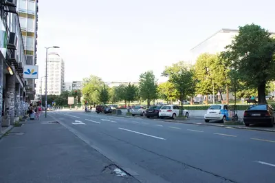 a street with cars parked on the side of the road at Omia in Belgrade