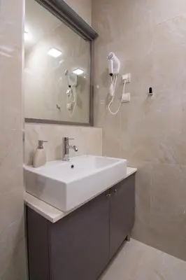 a bathroom with a white sink and a mirror at Omia in Belgrade