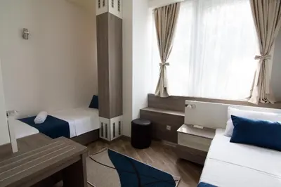 a small room with two beds and a window at Omia in Belgrade