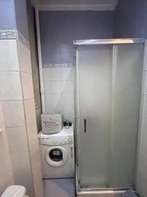 a washer and dryer in a small bathroom at Terazije Square Lux Apartment in Belgrade