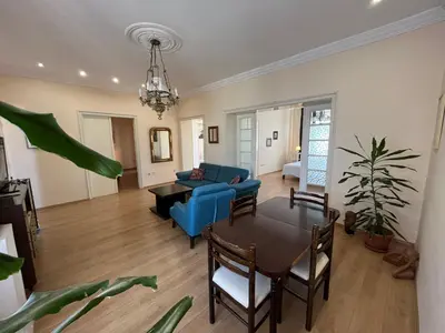 a living room with a blue couch and a table at Terazije Square Lux Apartment in Belgrade