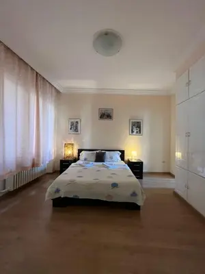 a bedroom with a bed and two lamps on tables at Terazije Square Lux Apartment in Belgrade