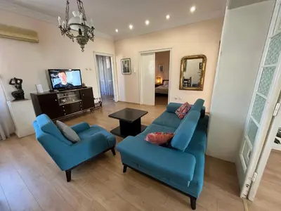 a living room with two blue couches and a tv at Terazije Square Lux Apartment in Belgrade