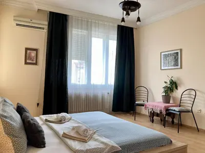 a bedroom with a bed and a window at Terazije Square Lux Apartment in Belgrade