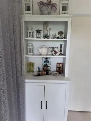 a white shelf with dishes and vases on it at Šumska kuća Sandy in Banatski Karlovac