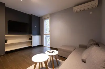a living room with a couch and a tv at Central Park Apartments in Belgrade