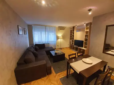 a living room with a couch and a table at Central Park Apartments in Belgrade