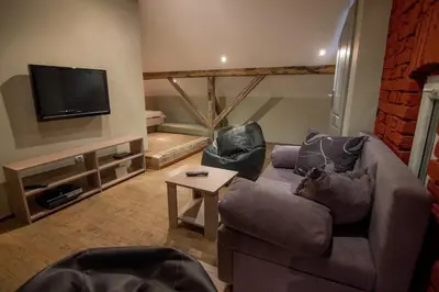 a living room with a couch and a tv at Central Park Apartments in Belgrade