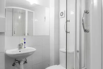 a bathroom with a toilet and a sink and a shower at Central Park Apartments in Belgrade