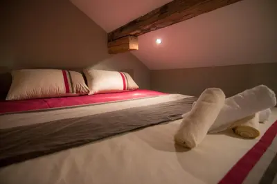 a bedroom with a bed with two white towels on it at Central Park Apartments in Belgrade