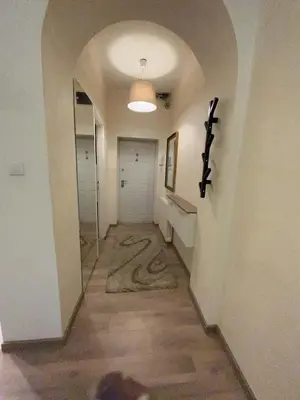 a hallway with an archway and a hallway with a door at Apartment Bubble in Belgrade