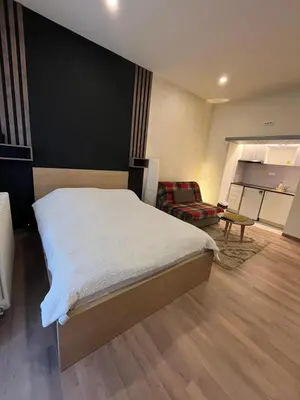 a bedroom with a bed and a living room at Apartment Bubble in Belgrade