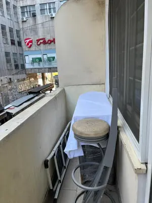 a stool sitting on a balcony with a table at Apartment Bubble in Belgrade