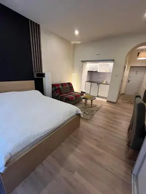 a bedroom with a bed and a living room at Apartment Bubble in Belgrade
