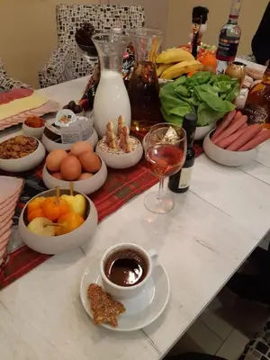 a table topped with bowls of food and a glass of wine at Apartments Exclusive in Belgrade