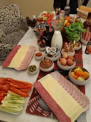 a table with different types of cheese and other foods at Apartments Exclusive in Belgrade