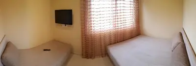 a small room with two beds and a window at Apartments Exclusive in Belgrade