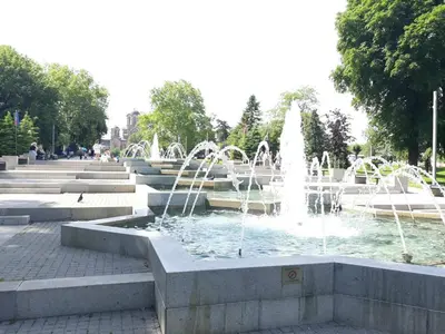 a fountain with water fountains in a park at St. Marko Church App in Belgrade