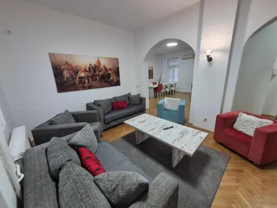 a living room with a couch and a table at BUDGET - Authentic Belgrade Centre Apartment #4, 3 Bedrooms, 1 full Bathroom, 1 Toilet in Belgrade